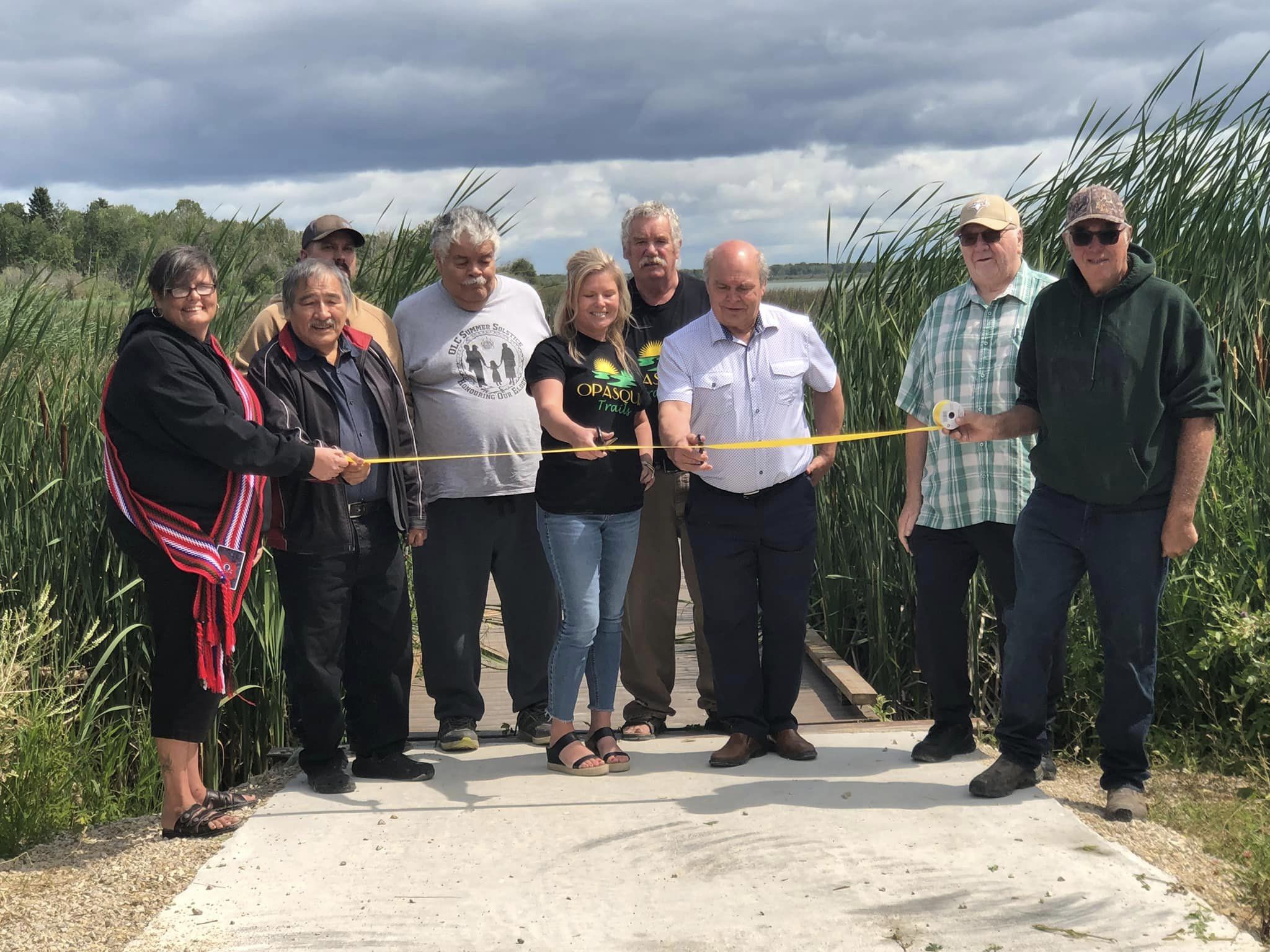 Grace Lake boardwalk grand opening with volunteer team cutting the ribbon